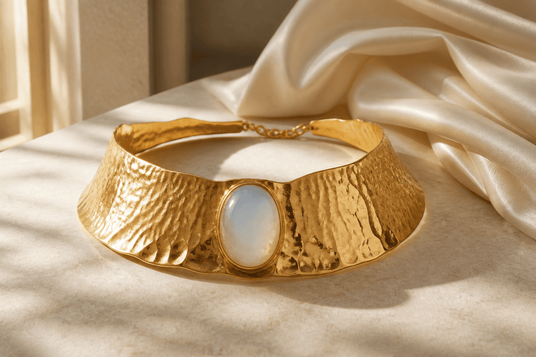 Hammered gold collar with an oval moonstone on limestone